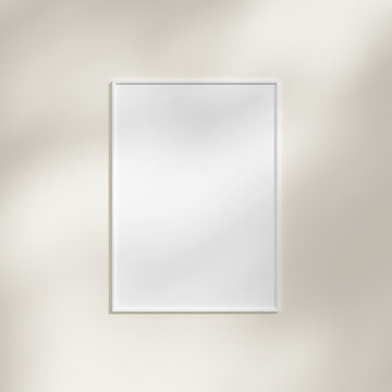 Frame hanging on a white wall mockup with leaf shadow