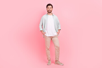 Fototapeta na wymiar Full length photo of nice young male hands pockets shopping banner model wear trendy blue garment isolated on pink color background
