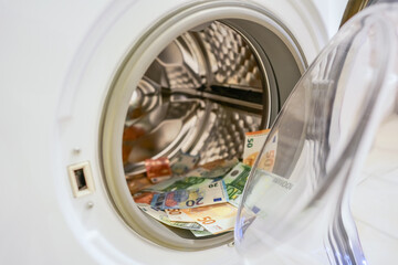 Money in washing machine, closeup view