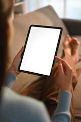 Closeup woman holding empty screen of digital tablet on sofa.