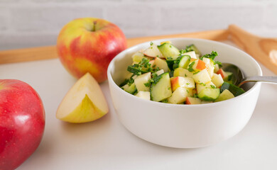 Cucumber salad with apples marinated with honey, lemon juice, olive oil and chopped parsley