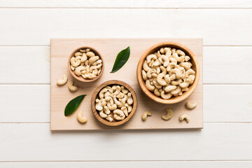 cashew nuts in wooden bowl on table background. top view. Space for text Healthy food