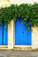 Fototapeta na wymiar Beautiful facade of a house with blue door in the center of the city,