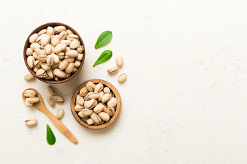 Fresh healthy Pistachios in bowl on colored table background. Top view Healthy eating concept. Super foods