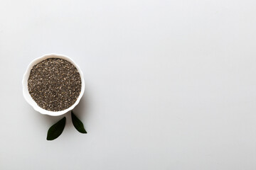 Chia seeds in bowl on colored background. Healthy Salvia hispanica in small bowl. Healthy superfood