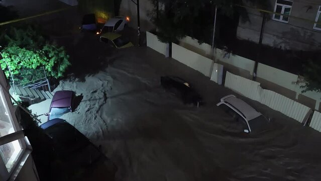 Sochi - July 24, 2022. Catastrophe. Night. Flooding on a city street. Cars sink in muddy rain