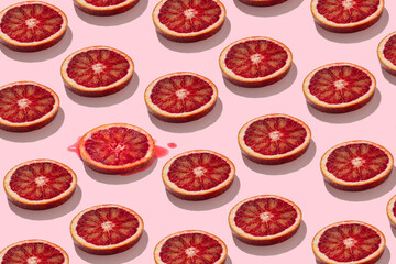 trendy seamless flat lay pattern of juicy red orange or grapefruit slices on pastel pink background funny summer concept