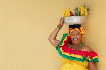 Cheerful fresh fruit street vendor aka Palenquera in the Old Town of Cartagena de Indias, Colombia....
