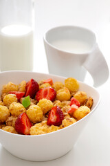 Mueslis with strawberry in a  white cup on the white table for healthy breakfast