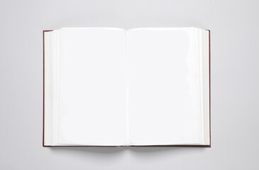 Open blank book with white pages on a gray background. Template for design, mock up