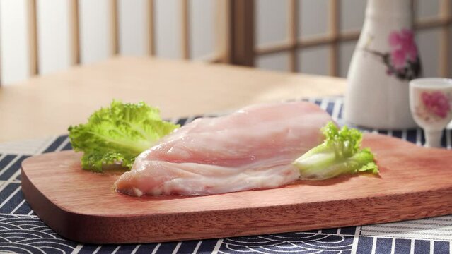 Fresh chicken breast on a simple background