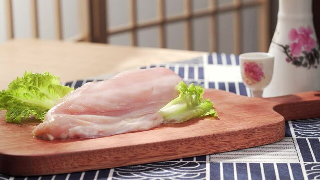 Fresh chicken breast on a simple background