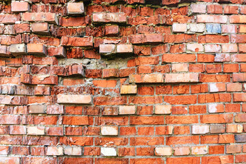 Close up of an old crumbling red brick wall