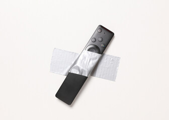 Tv remote fixed with adhesive tape on white background. Conceptual pop, contemporary art, minimalist still life