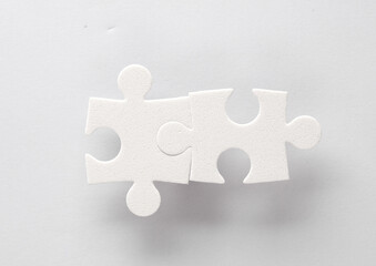 White jigsaw puzzle pieces on a gray background.