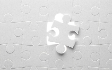 Unfinished white jigsaw puzzle close up