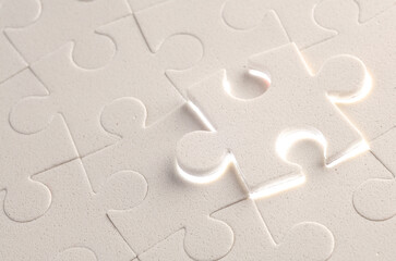 Close-up of a white jigsaw puzzle piece