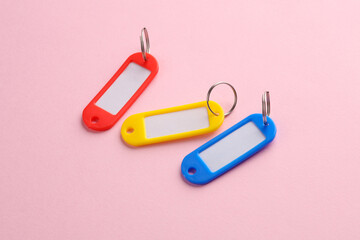 Plastic key tags on pink background