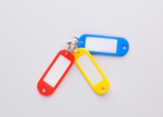 Plastic key tags on gray background