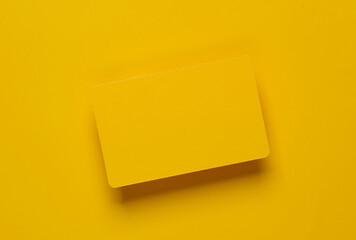 Mockup of yellow blank bank card on yellow background. Template for design