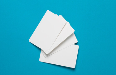 Stack of white empty bank cards on a blue background. Template for design