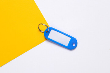 Plastic key tag on yellow white background