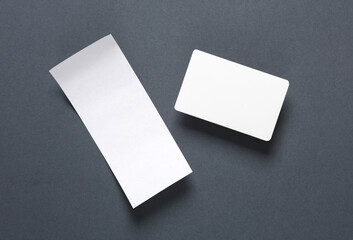 Mockup of white blank bank card with chip and white check tape on dark background. Template for design. Top view