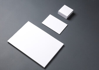White empty sheets of paper of different shapes and sizes on a dark background