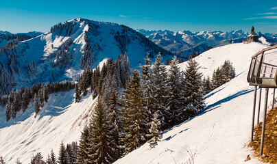 Fototapeta premium Alpine winter view with a chapel at Mount Wallberg, Rottach-Egern, Lake Tegernsee, Bavaria, Germany