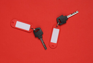 Plastic tags with keys on red background