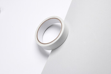 Roll of white duct tape on gray-white background. Creative layout