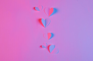 Paper cut hearts in red blue neon light