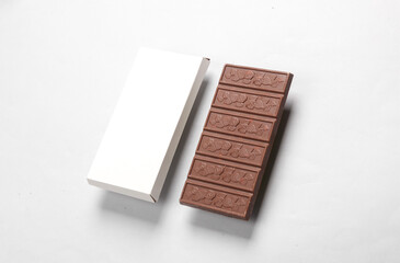 Mockup of white cardboard box with chocolate bar on gray background