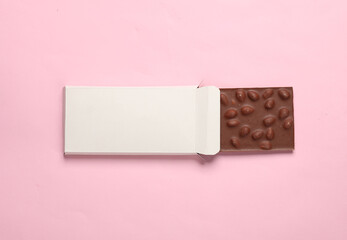 Mockup of white cardboard box with chocolate bar on pink background