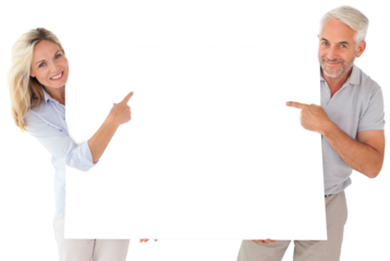 Happy couple holding and pointing to large poster