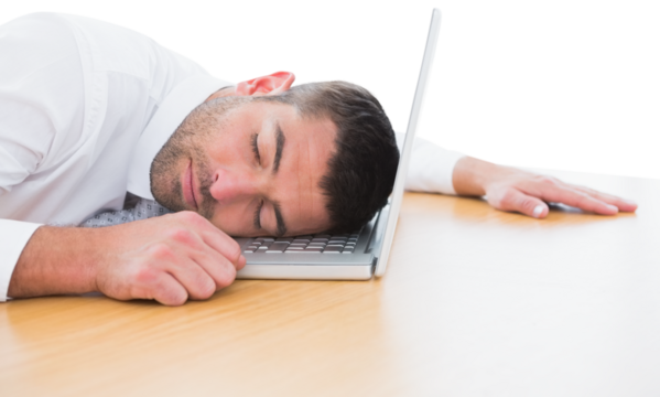 Businessman resting head on laptop