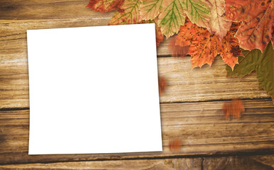 Page on table with autumn leaves