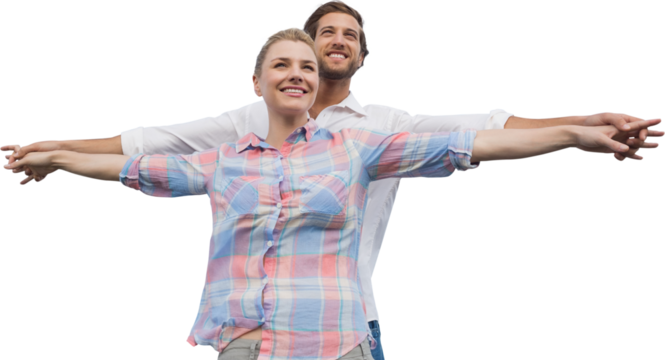 Happy couple standing with arms outstretched