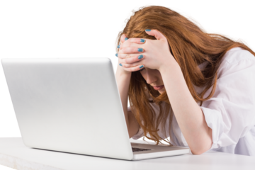 Pretty redhead working on laptop