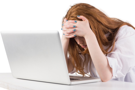 Pretty redhead working on laptop