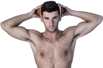 Portrait of a shirtless man holding ball over head