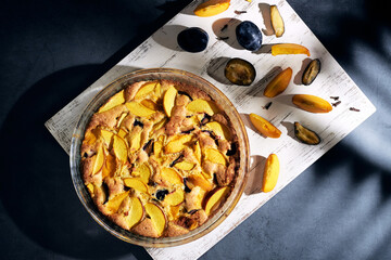 Delicious fruit cake with plums pie. Sweet pie, tart with fresh plums. Top view
