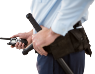 Mid section of security officer holding walkie talkie and baton
