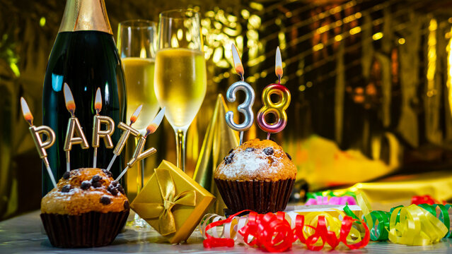 Happy birthday background with champagne glasses with number cake 38 . Beautiful birthday card with decorations copy space.