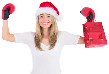 Festive blonde punching with boxing gloves
