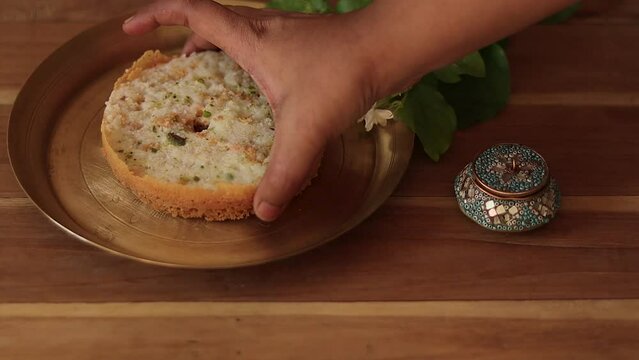 Ghewar or ghevar is a traditional sweet of rajasthan. It is made of milk, flour, ghee and sugar. Dry fruits and malai cream on top. It is served in brass plate. Photo taken with copy space	