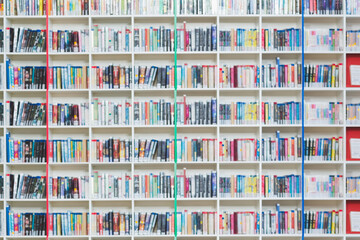 Multi colored bookshelf in library