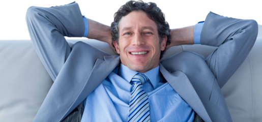Businessman smiling at camera sitting on couch