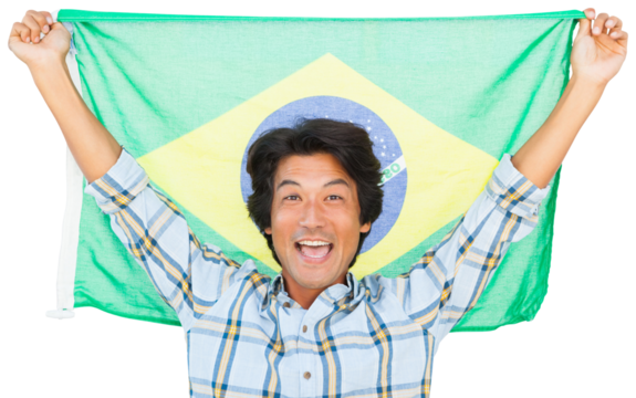 Football fan cheering while holding Brazil flag