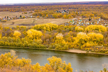 autumn landscape from the mountains to the village and the roofs of the houses, landscapes of Bashkortostan with the Belaya river